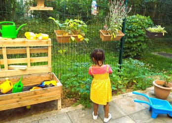 Enfant de dos dans le jardin de la crèche Babilou Montevrain Dublin